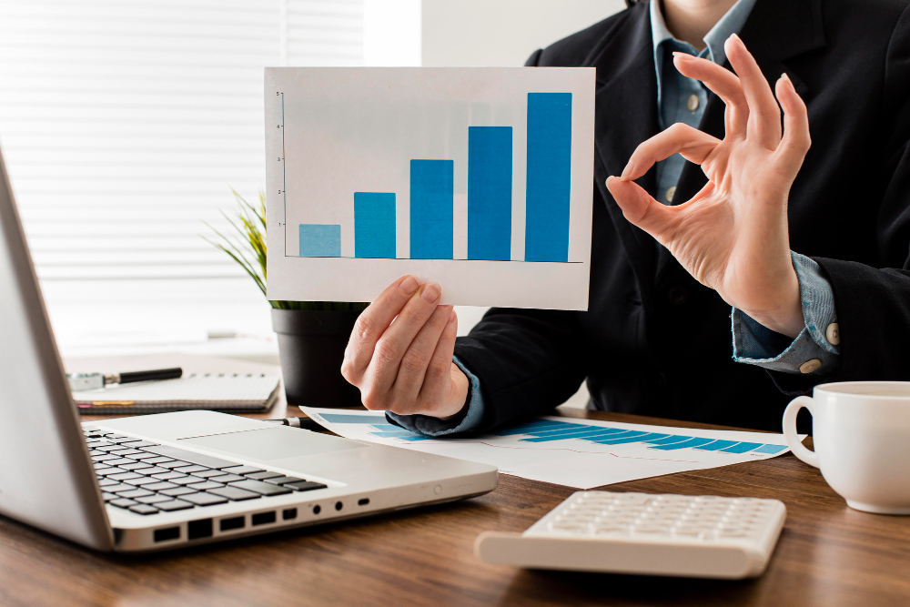 businessman-doing-ok-sign-while-holding-growth-chart