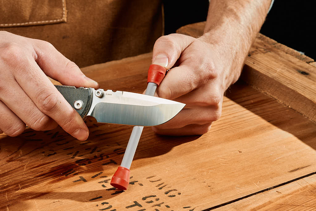 knife beeing sharpened in mini dog bone sharpener
