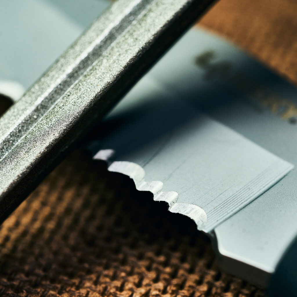 retractable pen sharpener for a dented knife